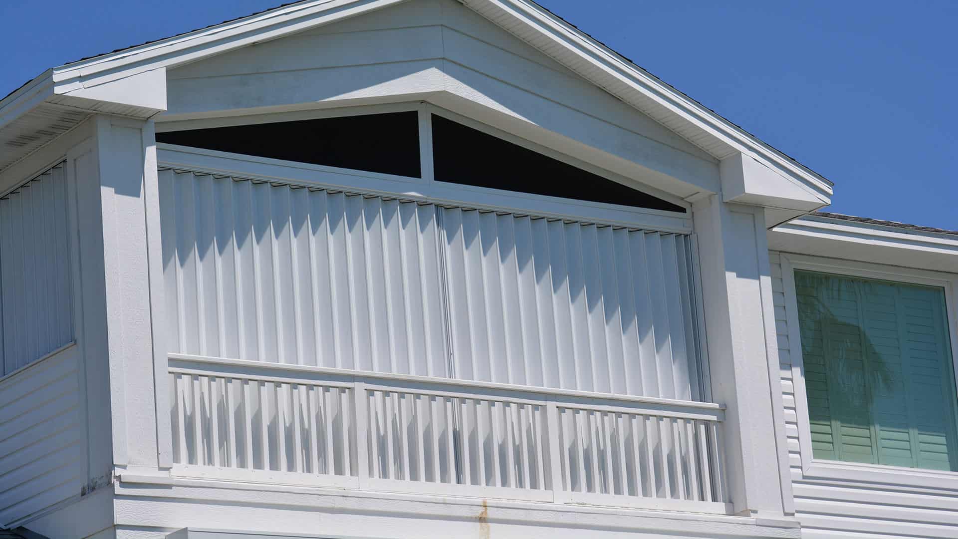 accordion shutters on white home