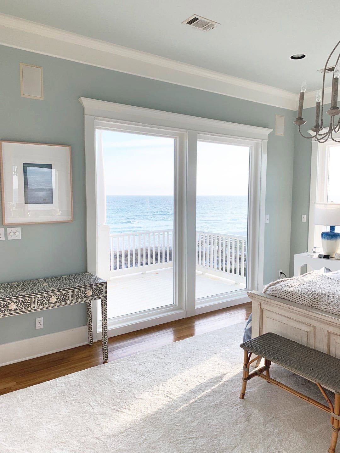 bedroom with sliding patio doors overlooking ocean