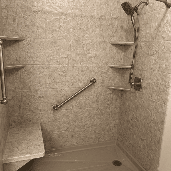 tile-like surrounds walk-in shower with corner caddies and grab bars