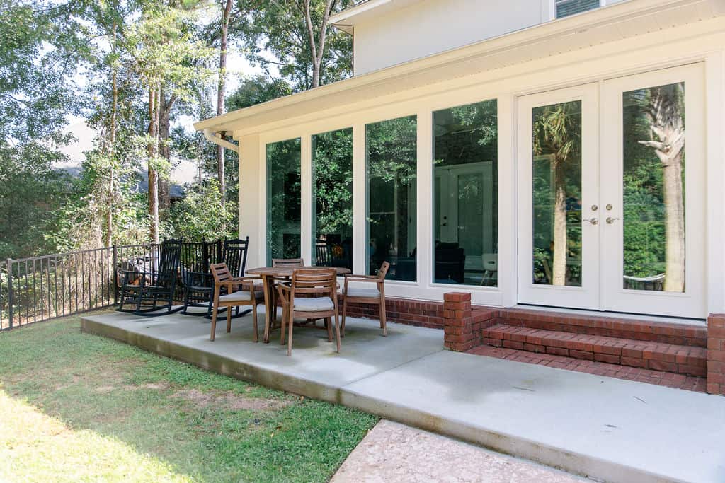 LatashaCarrawayPhotography-3388 glass sunroom with french patio doors ad wooden patio furniture