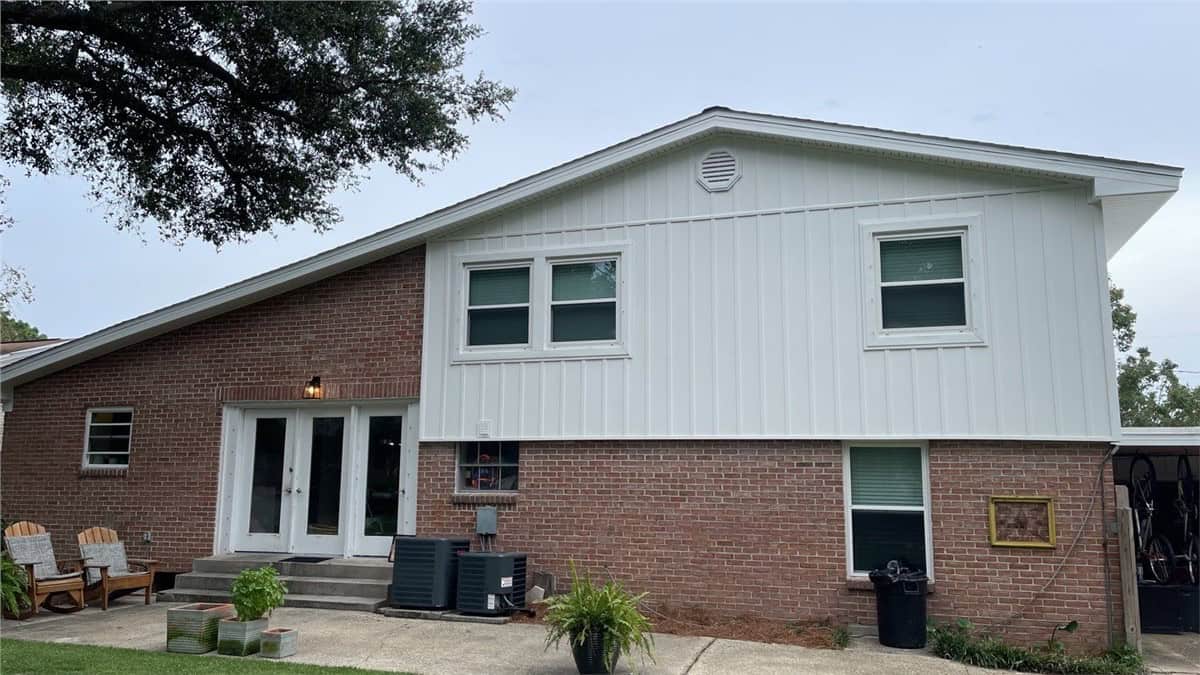 siding8 red brick home with white vertical siding
