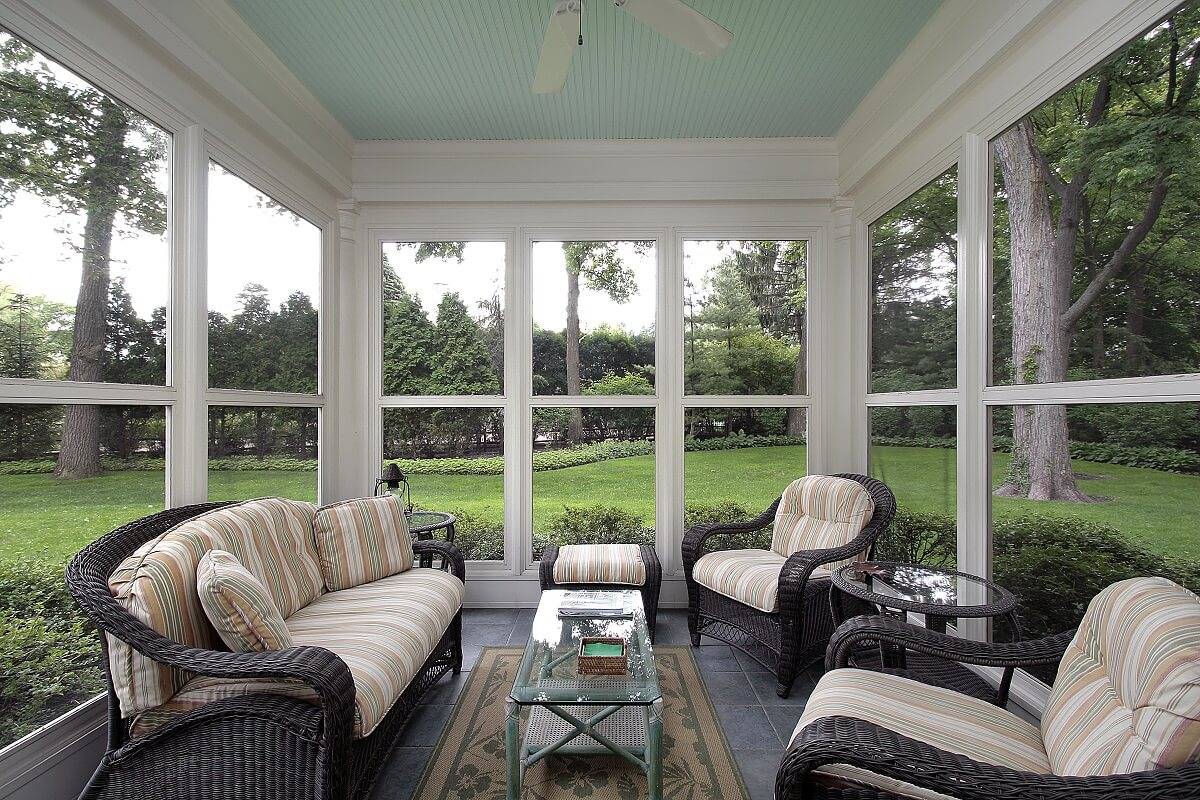 interior view of white three season room with patio furniture
