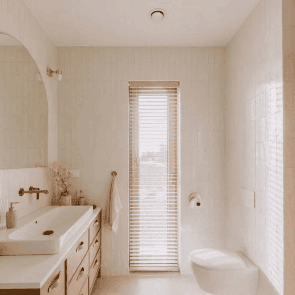 large marble shower with multiple grab bars