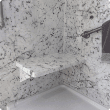 marble bath bench installation in a shower, showcasing high-quality home improvement and remodeling services by HTC Pros.