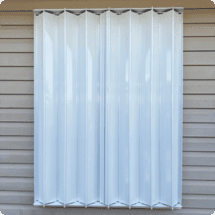 A New White Vertical Hurricane Protective Covering Installed on a Window