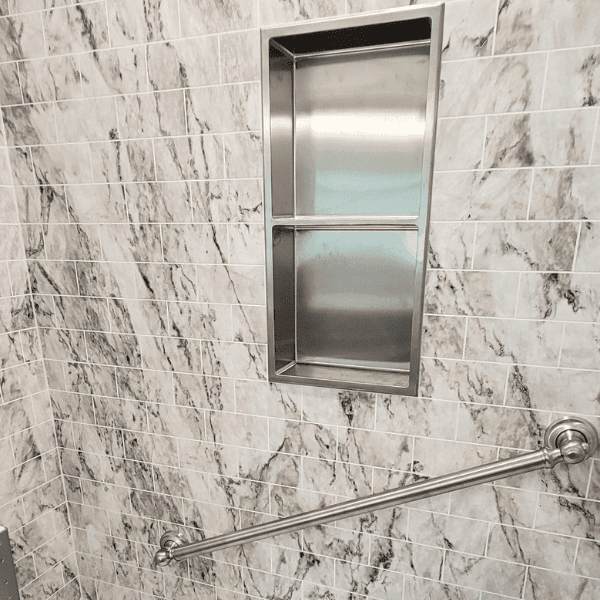 large marble shower with multiple grab bars