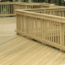 Custom wooden deck with railing showcasing outdoor living enhancement options for home improvement projects.