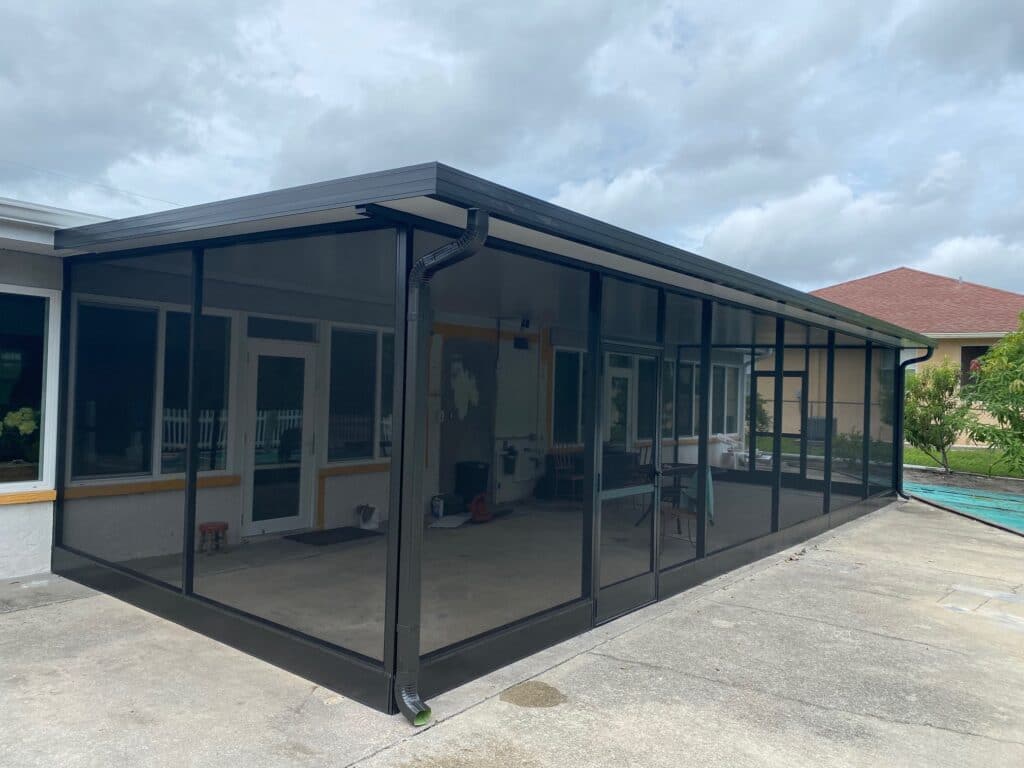 porch enclosure slide 3 Seamless black-framed screened patio enclosure providing outdoor protection and ventilation for residential homes.