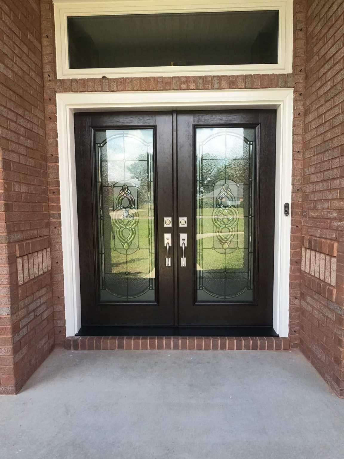 DCIM100GOPROGOPR3406.JPG Luxurious front entry French doors with large ornate glass centers. Work done by Hometown Contractors, Inc in Pace, FL.