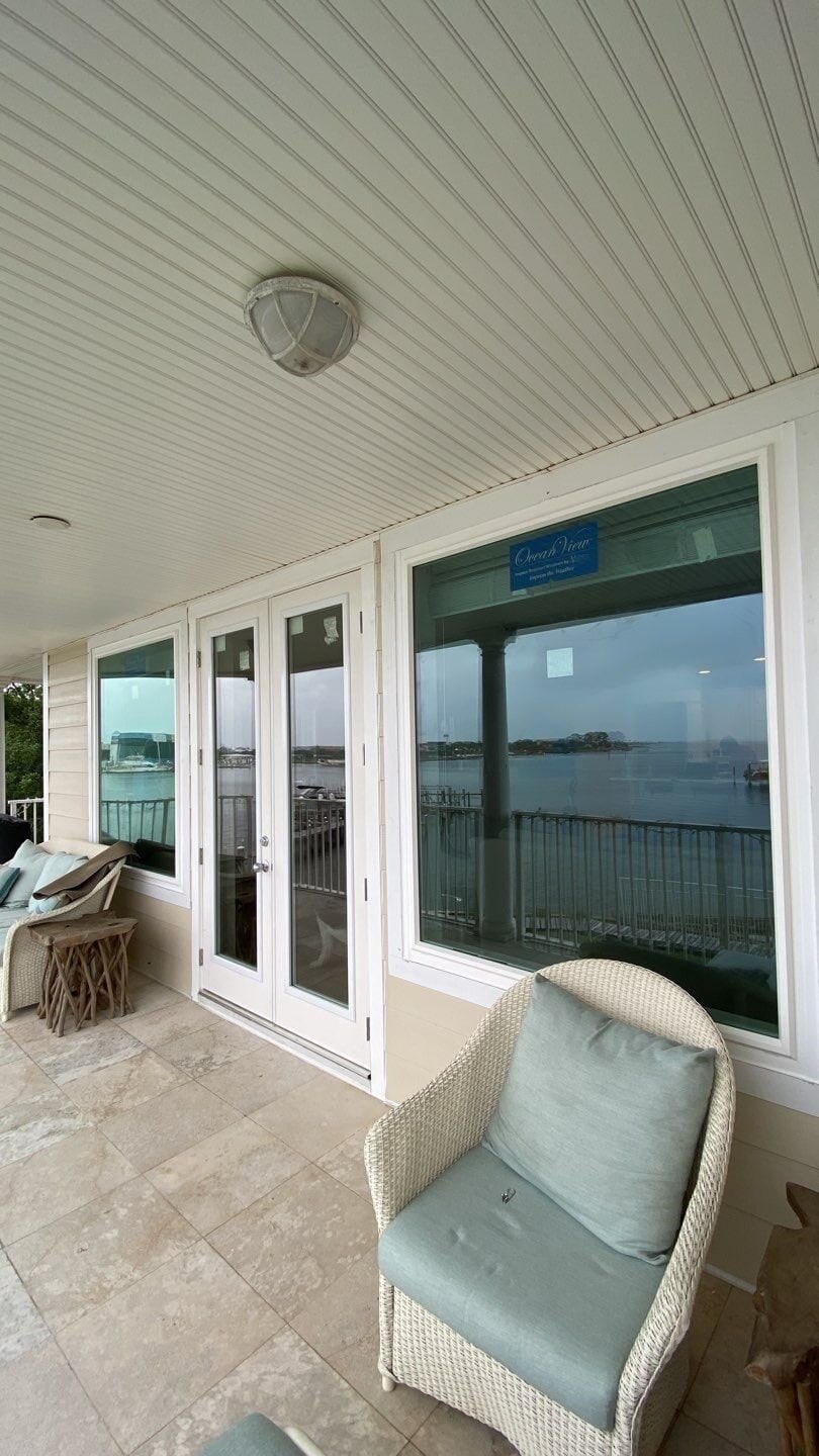 French Patio Doors 4 Home balcony with newly installed French patio doors installed by trusted Gulf Coast home improvement experts, Hometown Contractors, Inc.
