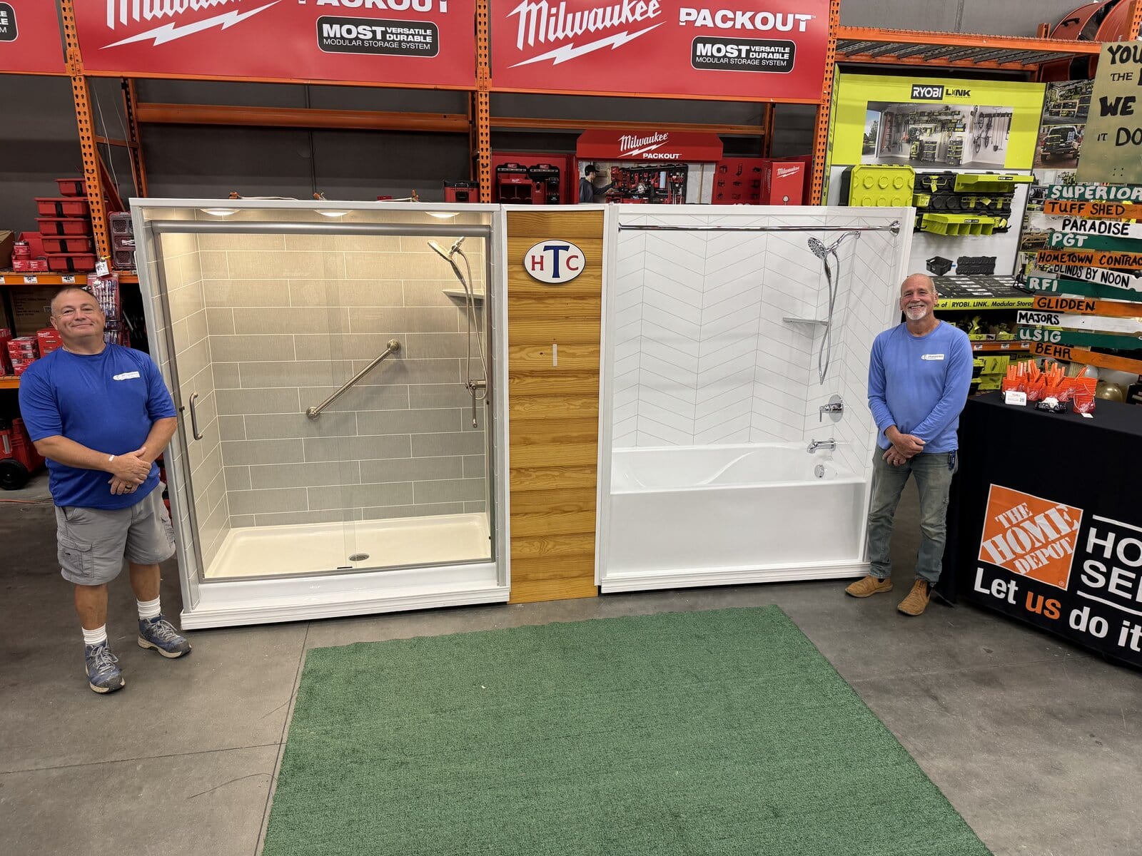 Hometown Contractors, Inc. expert installation team posing beside HTC SHowers and Baths on display at Home Depot Service Pro Event in Pace, FL 11/2025