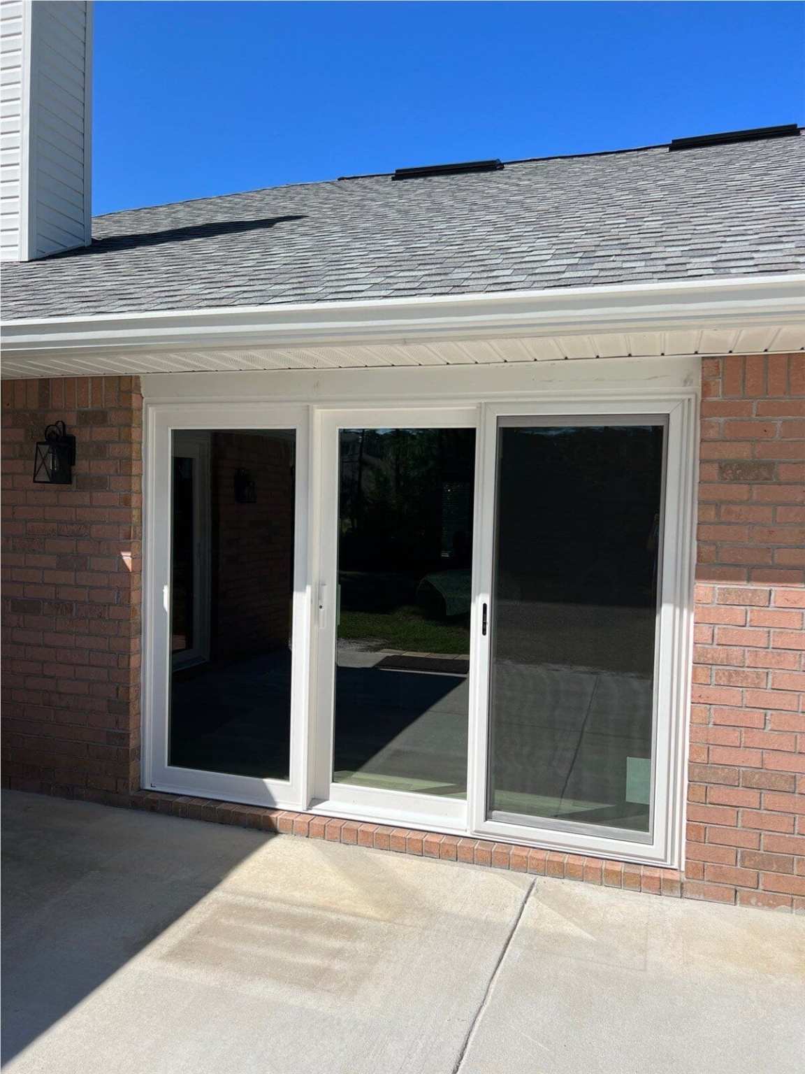 Sliding Patio Doors 0 Red brick home showcasing new sliding glass patio doors after installation by Hometown Contractors, Inc.