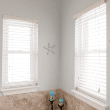 Modern black-framed window with scenic outdoor view, ideal for home improvement projects focusing on window replacements and upgrades.