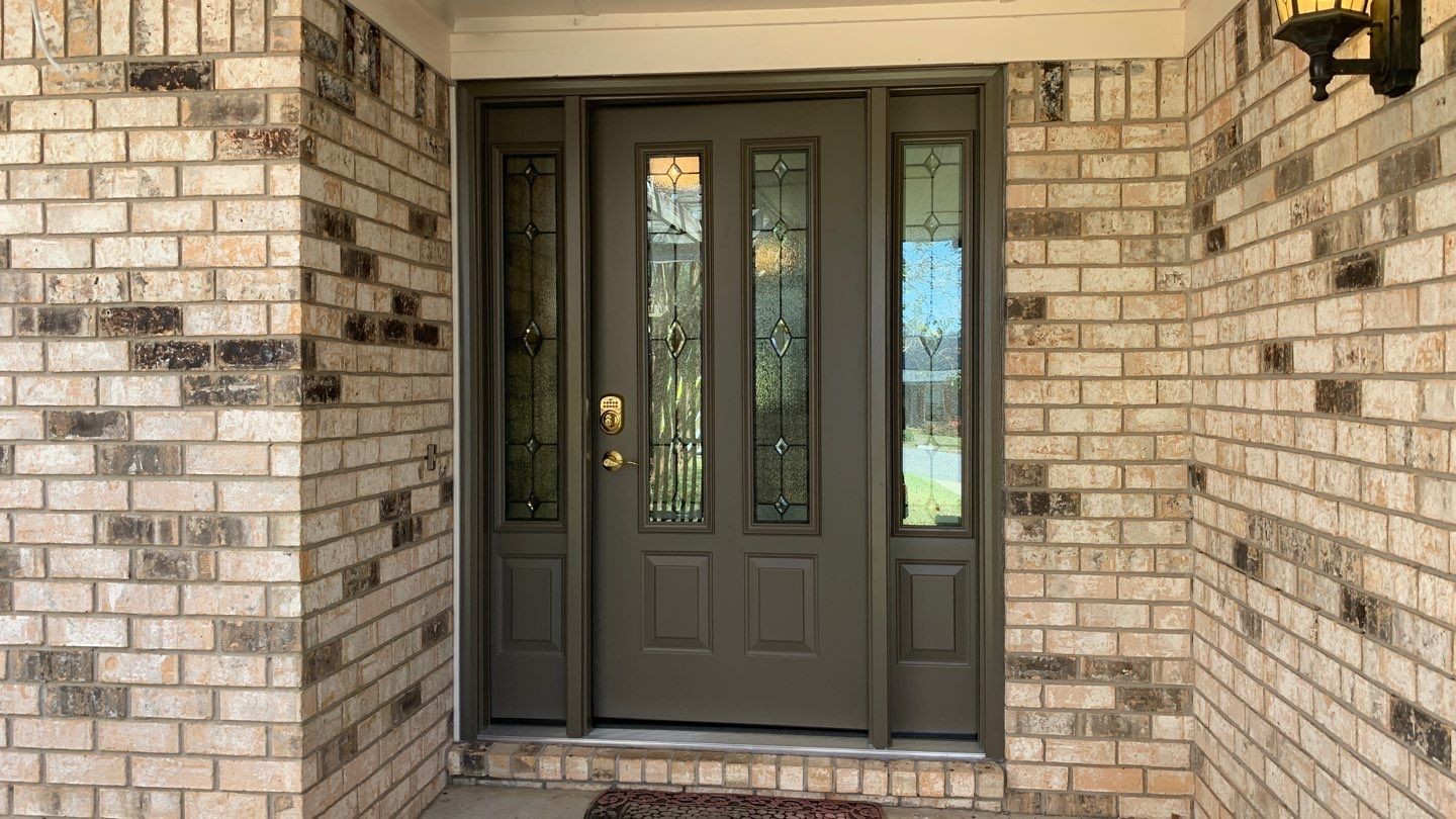 Gallery Brown Front Door Horizontal Horizontal angle of brown front entry door with sidelites on either side of the door and a gold door handle.
