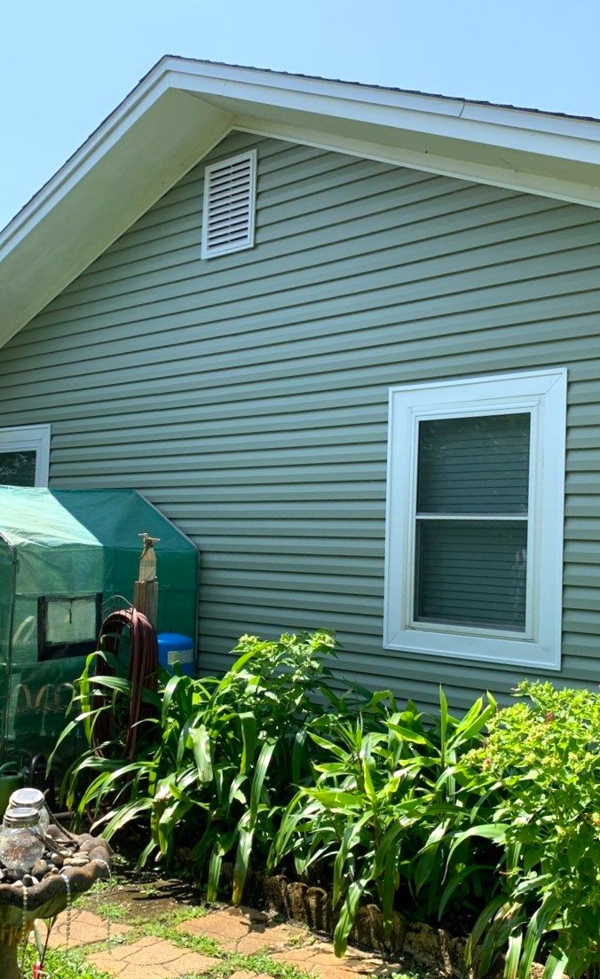 Gallery Green Siding Sage green vinyl siding with white trimmed window and white soffits