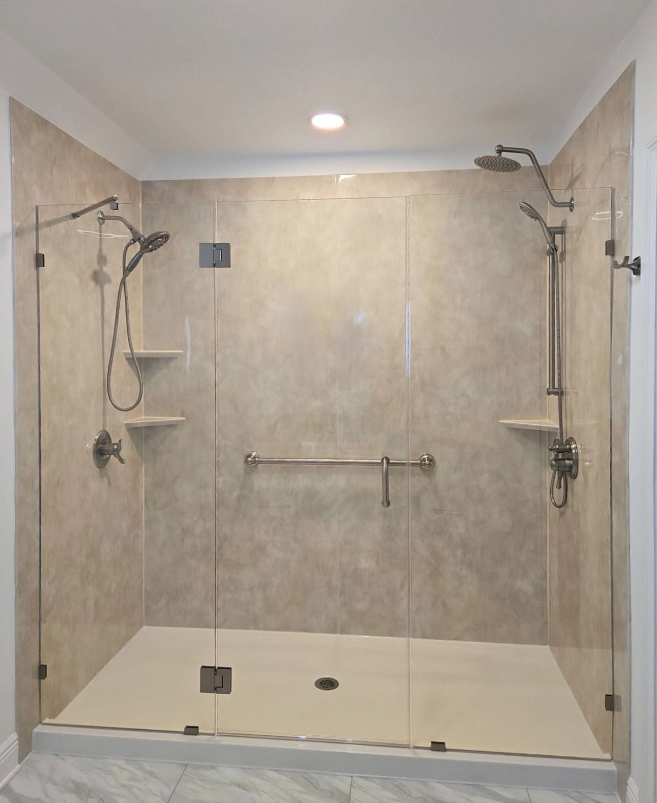 Gallery Large Beige Shower Large shower with beige walls and silver hardware. Two detachable silver showerheads with a silver rain showerhead.