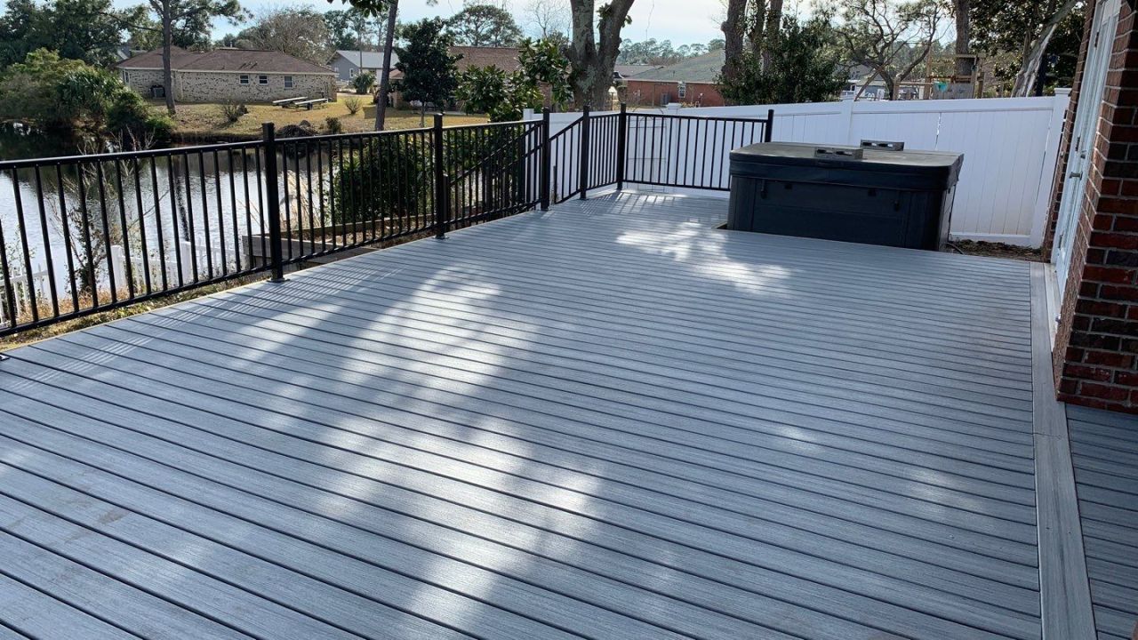 Gallery Gray Composite Deck Black Handrails Gray composite deck with black handrails and a view of a pond