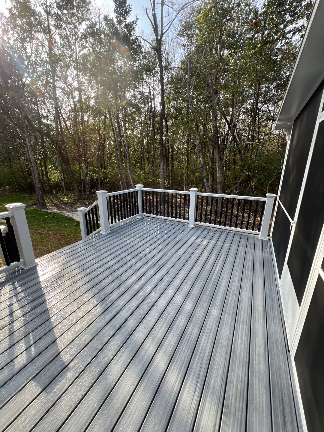 Gallery Gray Composite Deck Black and White Handrails1 Gray composite deck with black and white handrails and screen room attached to deck