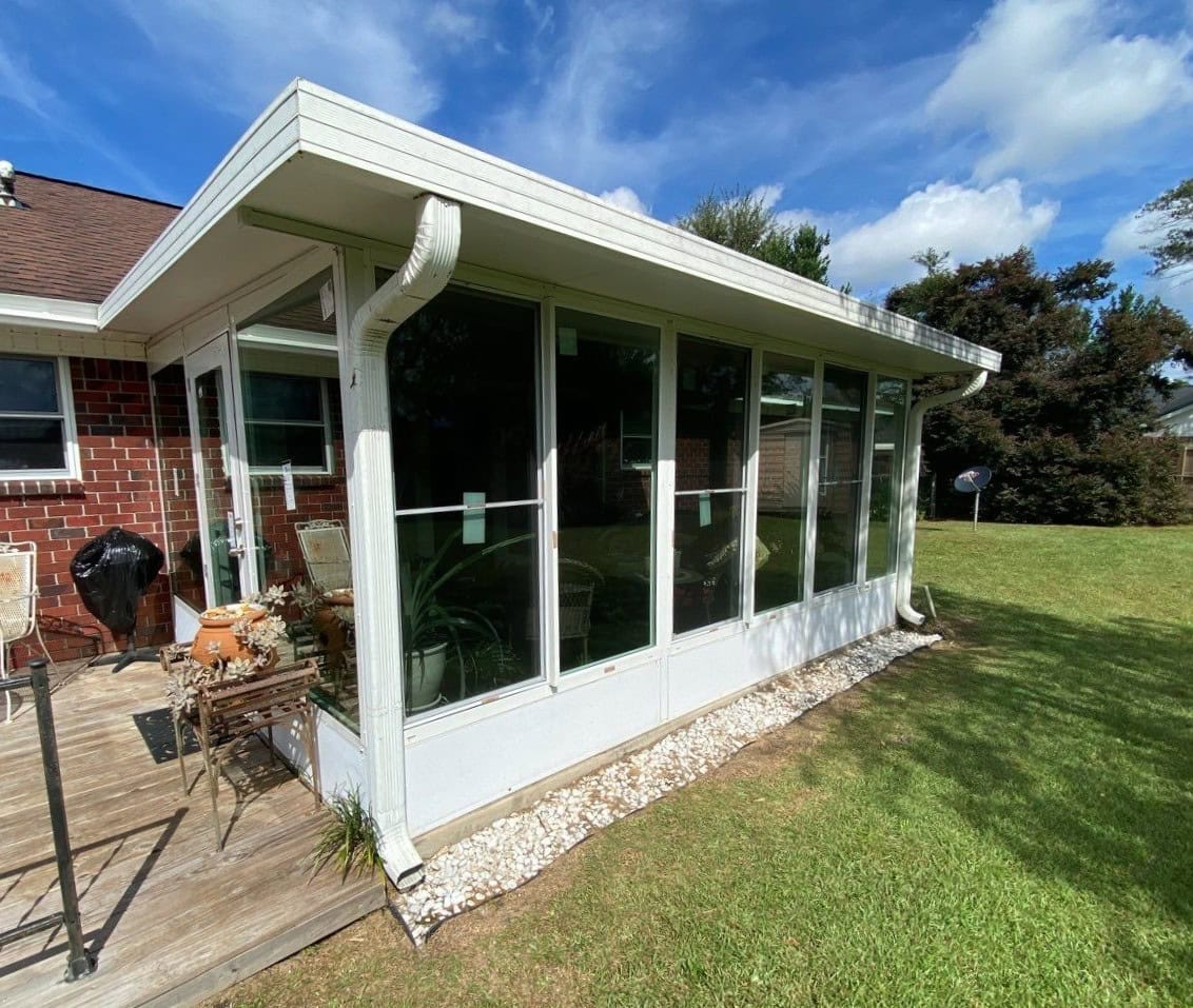 Gallery White Porch Enclosure White trimmed glass porch enclosure from the outside with white gutters