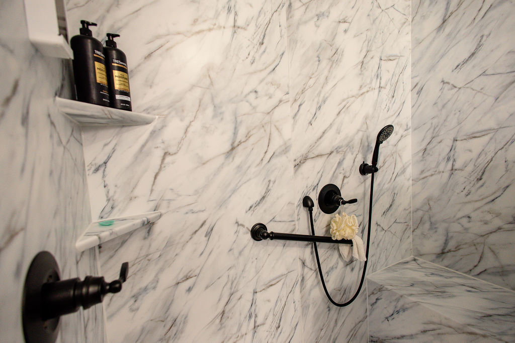 LatashaCarrawayPhotography-8444 Close-up shot of Bath accessories, including grab bar, detachable wand, seating, and corner shelves