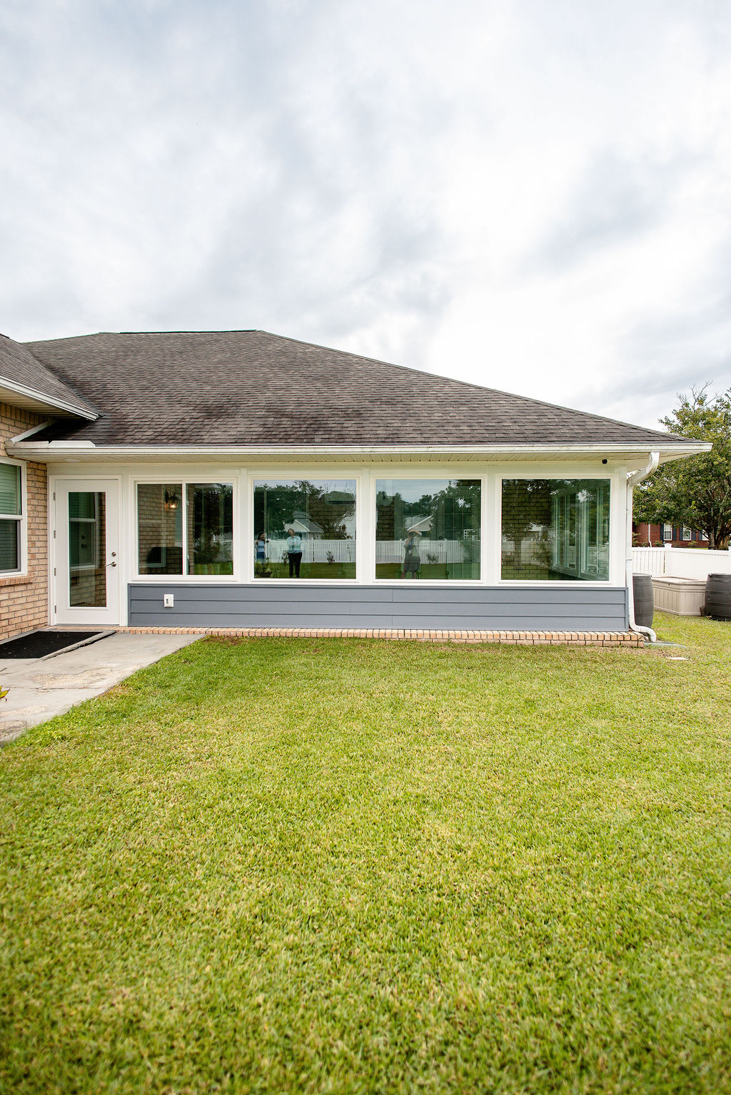 LatashaCarrawayPhotographyH.-9056 gray porch enclosure with picture windows and glass-center exterior door