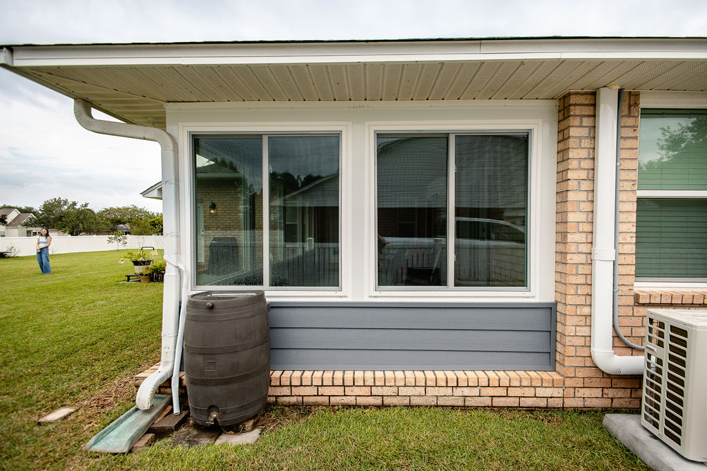 LatashaCarrawayPhotographyH.-9077 Gray hardy board porch enclosure with two sliding windows on a porch enclosure