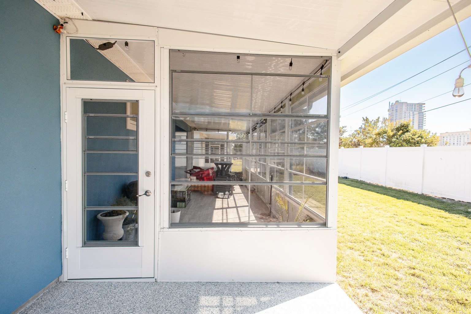 Vinyl Pane Room Existing white screen room with vinyl pane windows added inside.